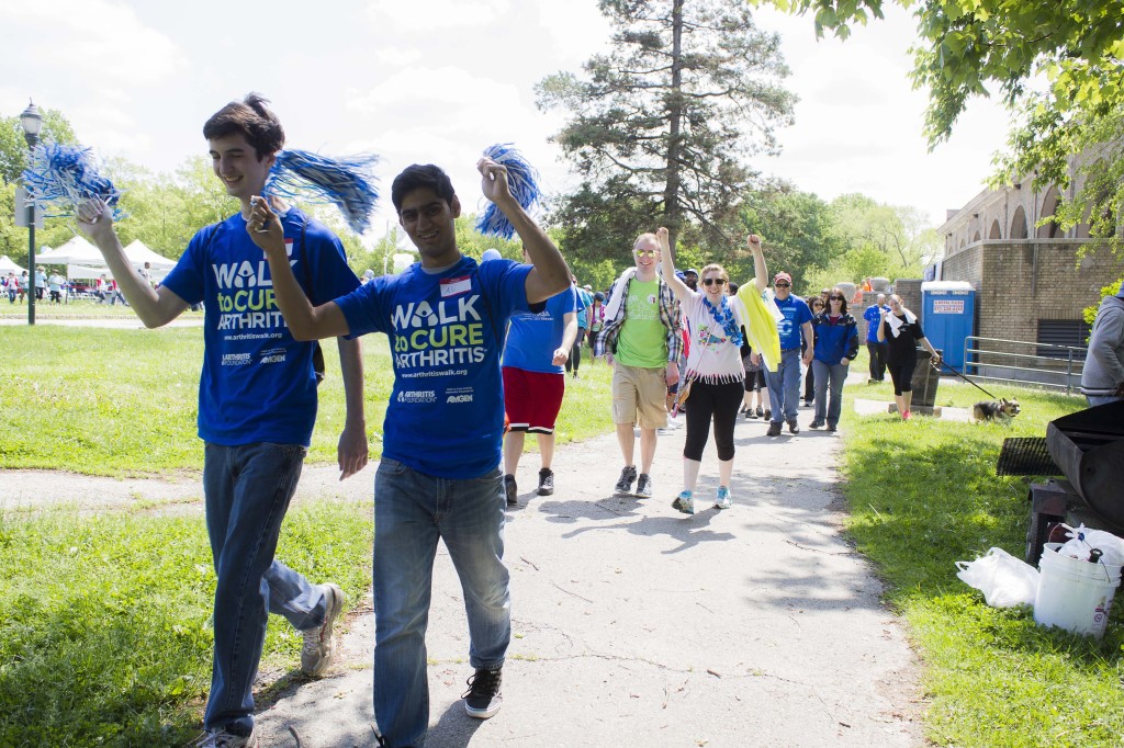 Locals cheer on walkers who are walking to raise funds to cure arthritis